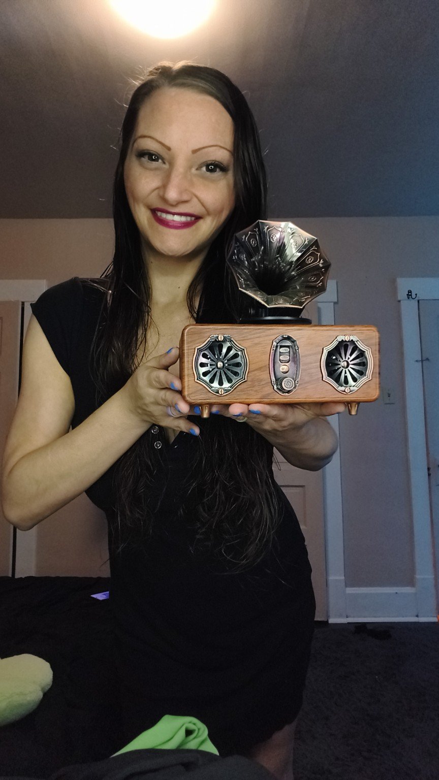 Ren holding a retro gramophone-style music player
